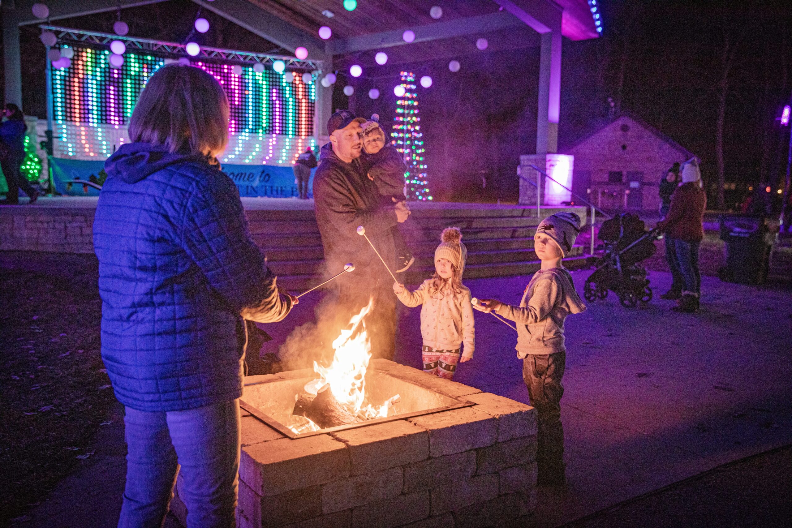 Kids roasting marshmallows over a firepit